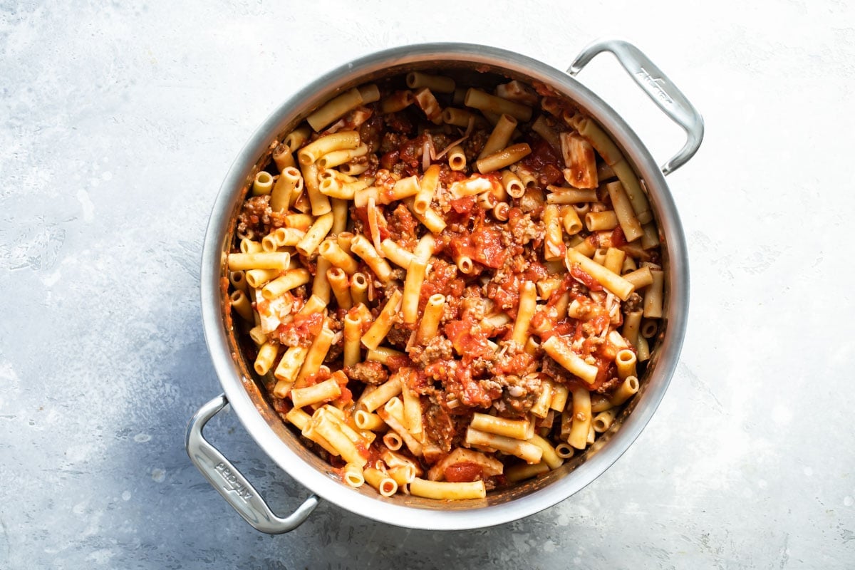 Ziti and meat sauce in a silver pot.