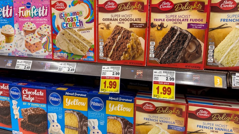 Grocery store shelves of boxed cake mixes